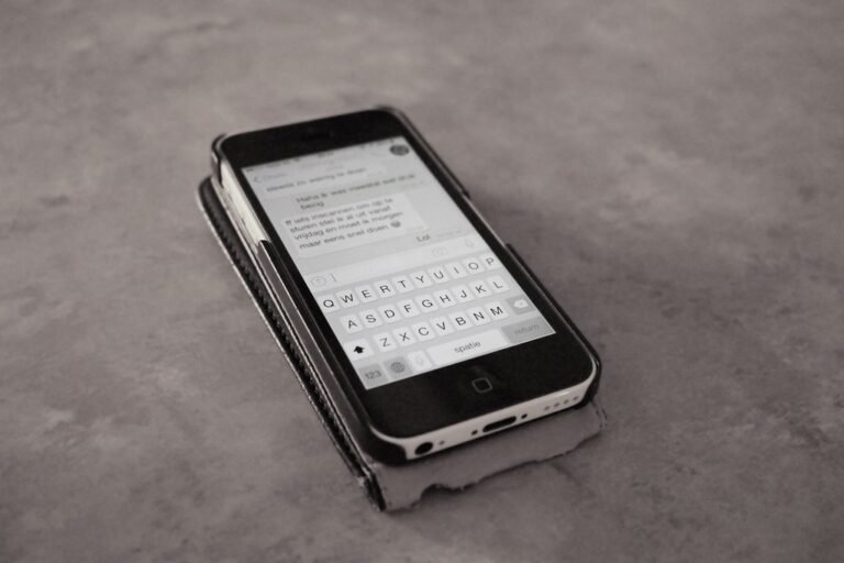 Person reading a text message on a smartphone illustrating toll road smishing scams